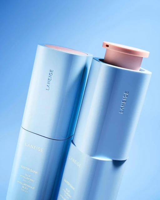 Two Laneige Water Bank Blue Hyaluronic Cream skincare products in light blue and pink tones against a light blue background.