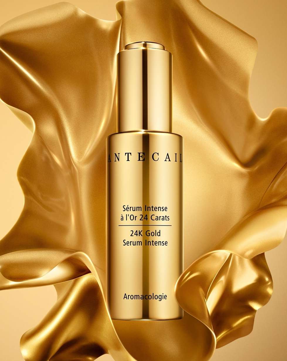 Gold serum by Chantecaille featuring skincare product on a gold satin background, showcasing luxury beauty and cosmetic product photography.