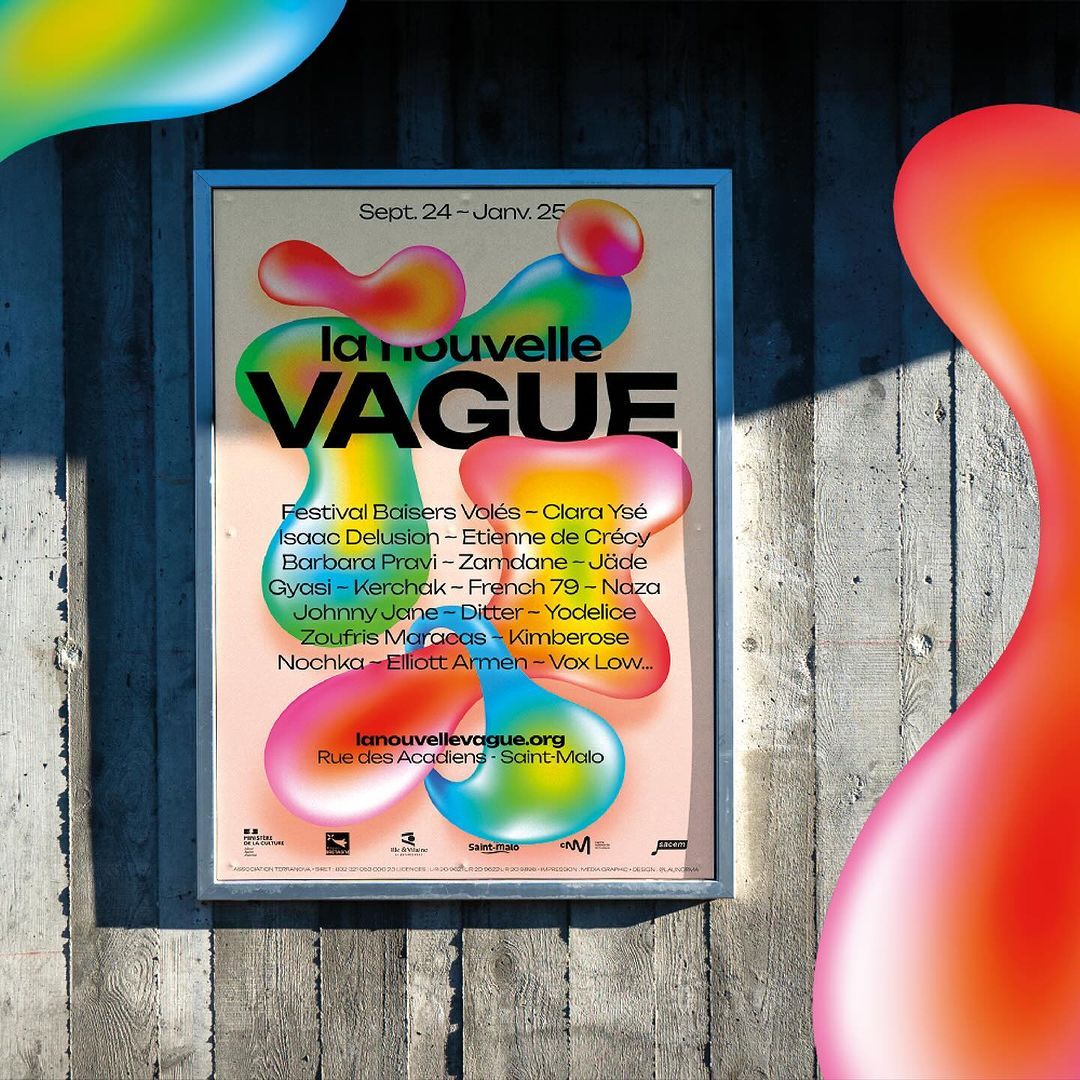 Eye-level shot of a framed poster on a textured wall featuring 'La Nouvelle Vague' event details and colorful abstract shapes.