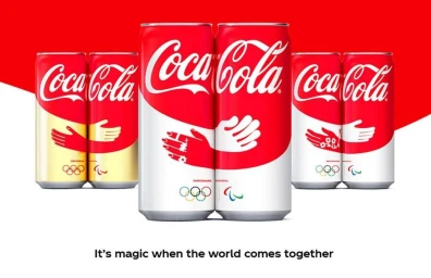 Coke cans with white and red wrapping graphic of hugging hands and Olympic rings by Laura Normand