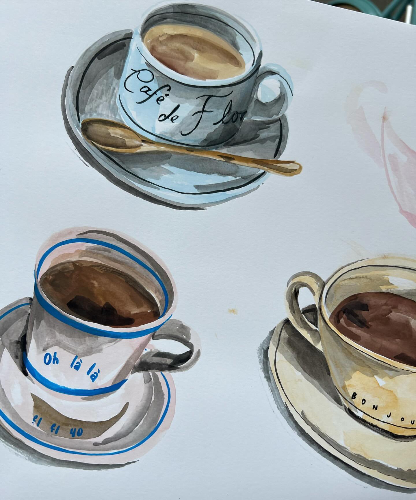 Watercolor painting of coffee cups with Cafe de Flore and other phrases on them, set against a plain white background.