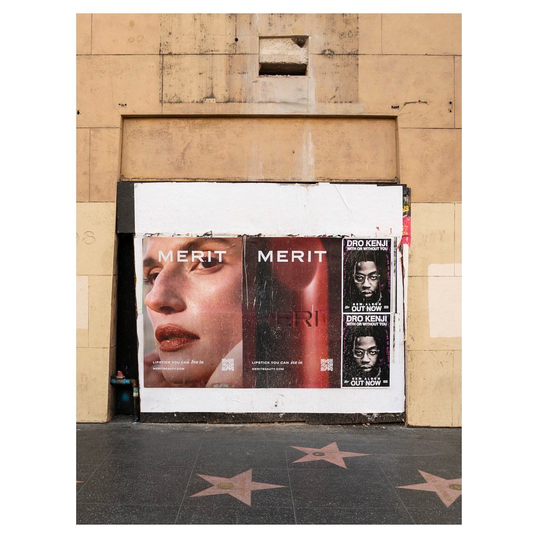 Beauty advertisements for makeup and music on a city street, showcasing urban lifestyle with muted colors and natural light.