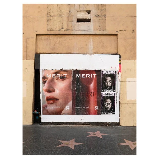 Beauty advertisements for makeup and music on a city street, showcasing urban lifestyle with muted colors and natural light.