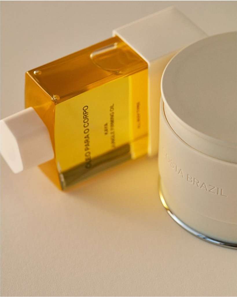 Still life shot of translucent bottle of body oil and moisturizing balm on a neutral background, showcasing beauty and skincare.