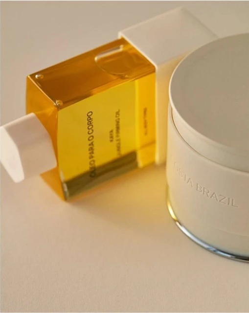 Still life shot of translucent bottle of body oil and moisturizing balm on a neutral background, showcasing beauty and skincare.