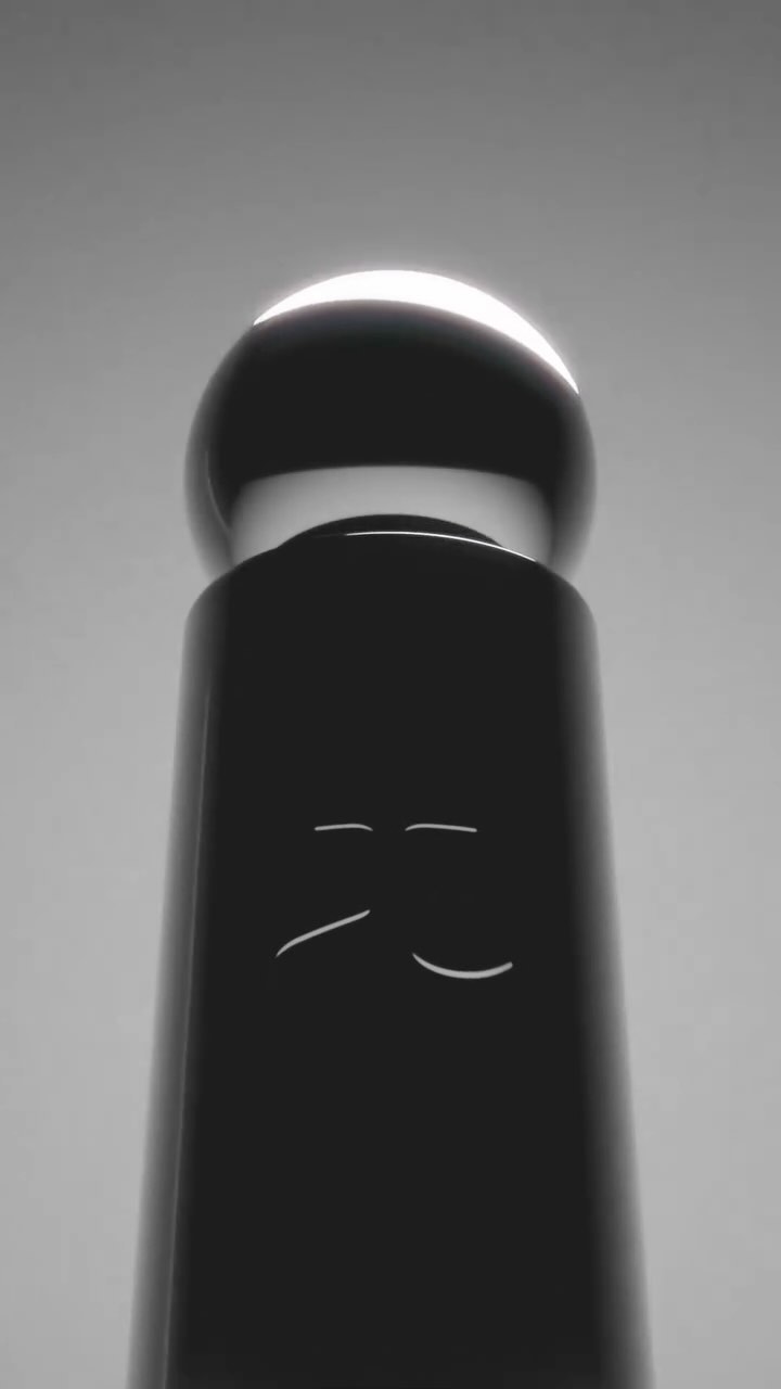 Abstract studio shot of a black cylinder topped with a glowing sphere, creating a minimalist and modern still life composition.