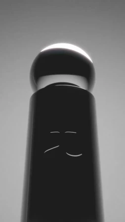 Abstract studio shot of a black cylinder topped with a glowing sphere, creating a minimalist and modern still life composition.