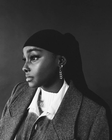 Monochrome portrait of a Black woman in a head covering and blazer by Lawrence Agyei