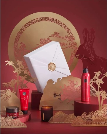 Luxurious beauty product set on a red backdrop with a rabbit and decorative elements, perfect for holiday or festive promotions.