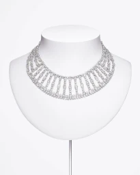 An ornate diamond choker necklace displayed on a white bust mannequin against a plain white background.