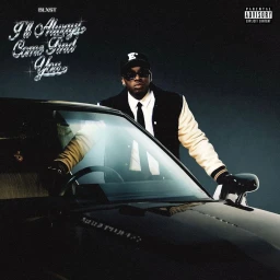 Man wearing sunglasses and a varsity jacket leaning on a black vintage car under dark studio lighting