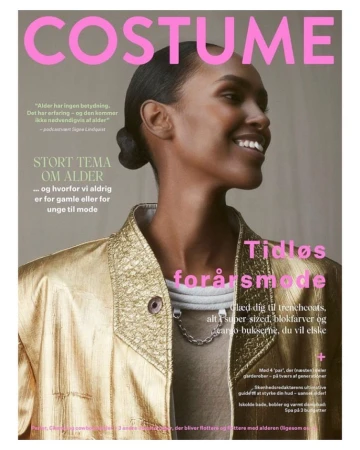 Fashion magazine cover featuring a smiling Black woman in a gold jacket. The Costume magazine promotes a spring fashion edition.