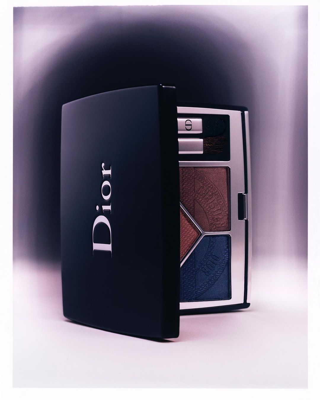 Dior eye shadow palette with various shades of brown and blue eyeshadows. Cosmetic product for beauty and makeup. Professional studio shot.
