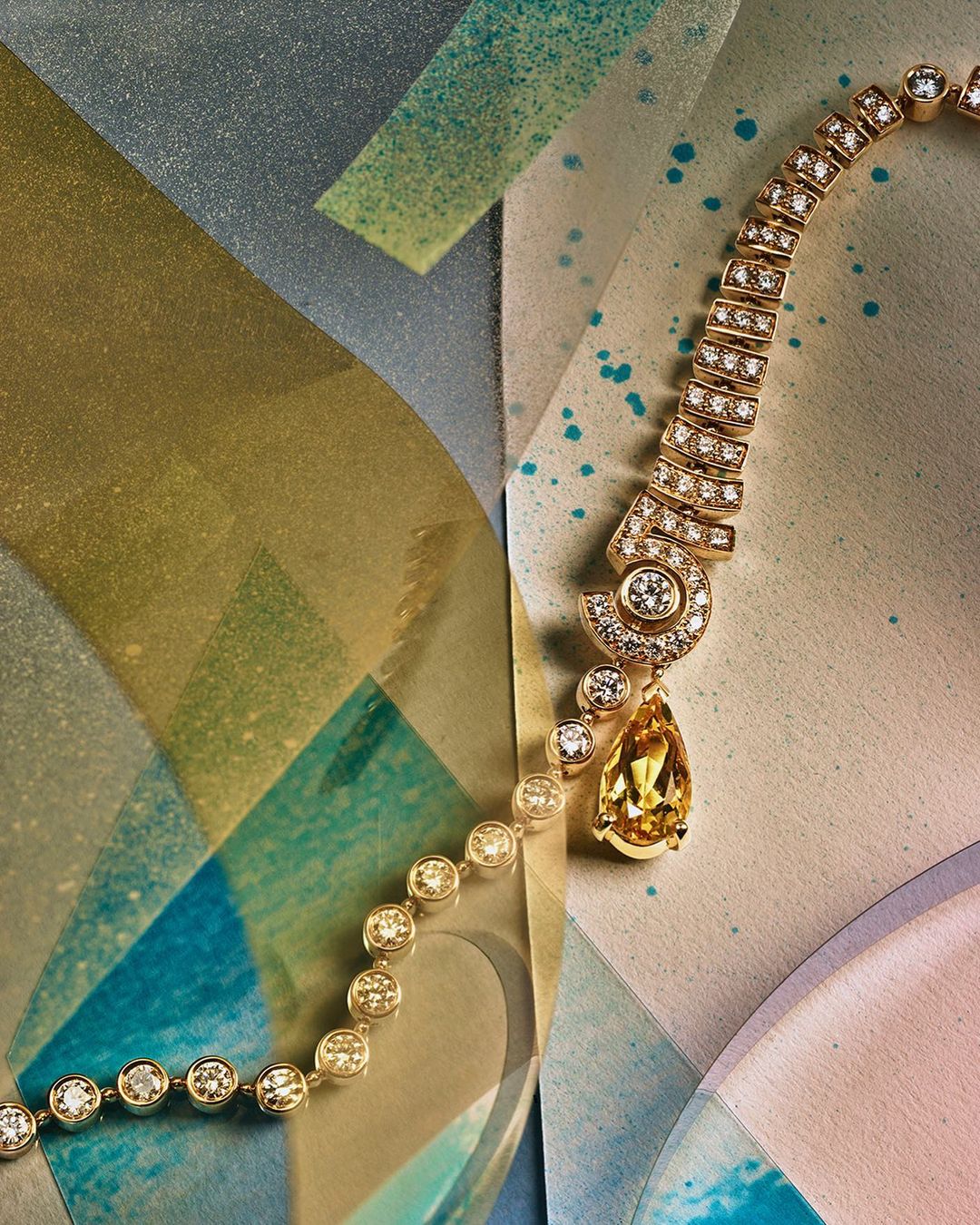 Elegant yellow gemstone and diamond necklace displayed against a textured geometric backdrop, emphasizing luxury and fine jewelry design.