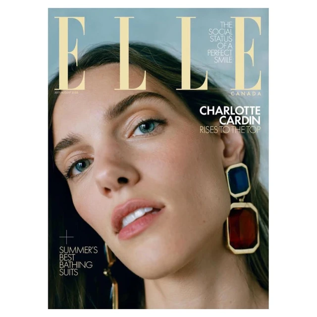 Elle Canada cover featuring Charlotte Cardin with blue and red geometric earrings, soft makeup, and a cool-toned background.
