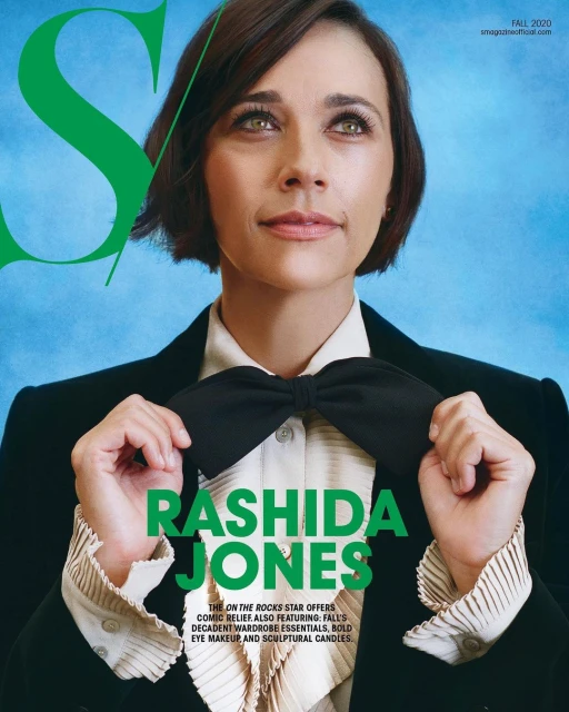 Magazine cover featuring Rashida Jones in a dark blazer adjusting a large black bow tie, with green 'S' logo and text overlay.