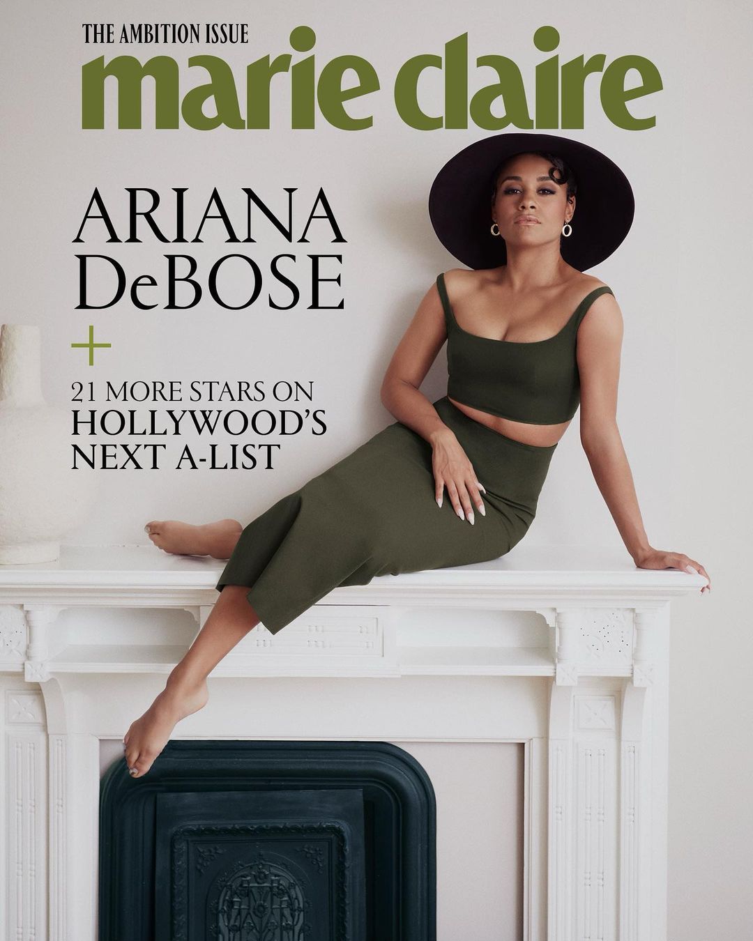 Magazine cover featuring Ariana DeBose wearing a two-piece olive outfit and black hat, posing on a white fireplace mantle.