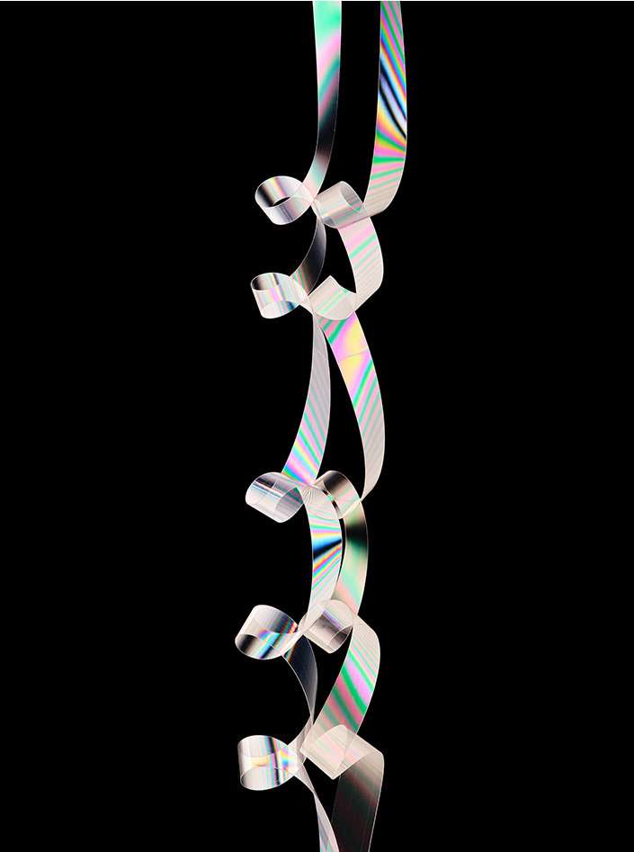 Abstract shimmering ribbons cascade down against a black background, creating a mesmerizing visual effect with iridescent colors.