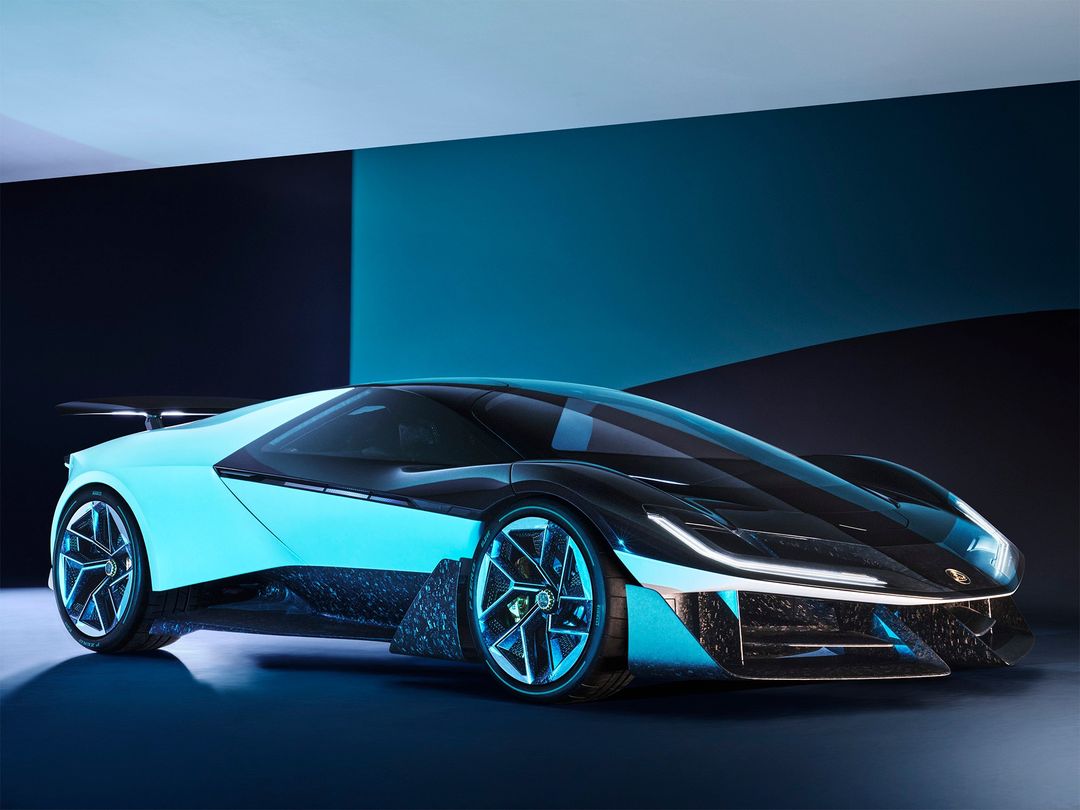 Sleek black and turquoise concept car with futuristic design in a studio, showcasing sharp angles, glowing accents, and aerodynamic features.