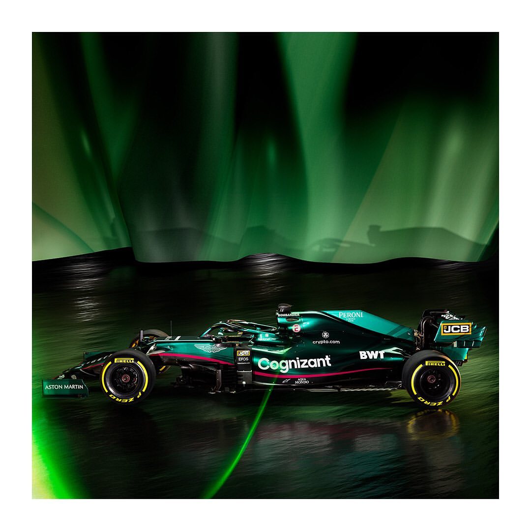An Aston Martin Formula 1 race car is showcased in a profile shot against a vibrant green background, sleek design and glowing tires.
