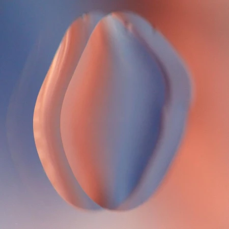 Abstract art with smooth shapes in a gradient of blue and peach tones, soft focus, and minimalistic composition.