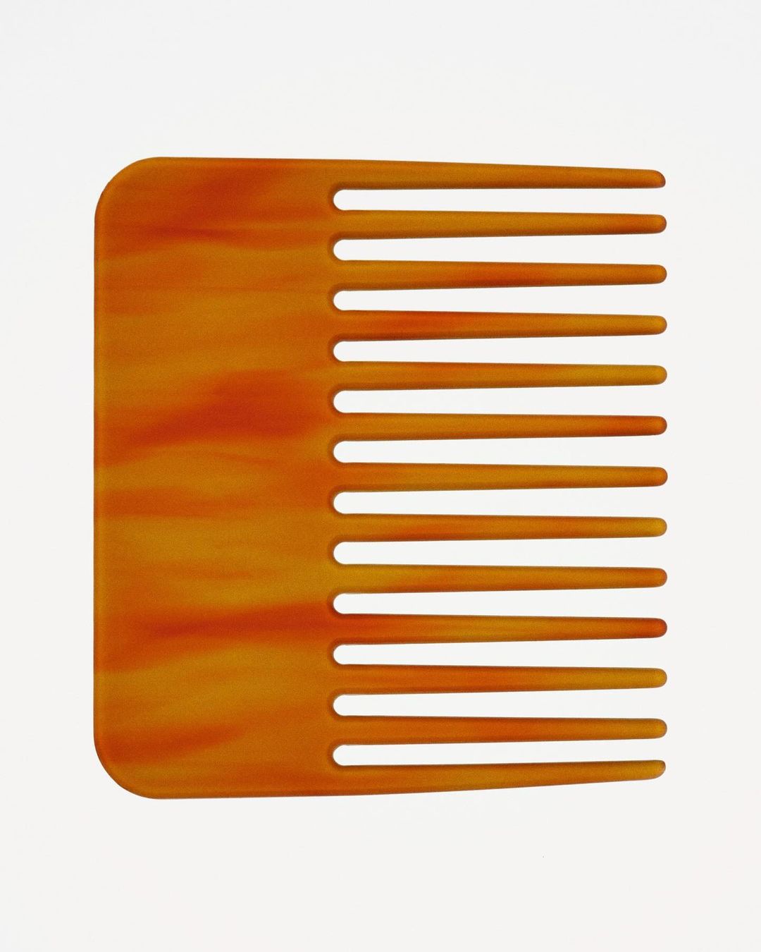 Close-up studio shot of a brown, patterned hair comb on a white background, used for detangling and styling hair.