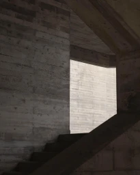 Architectural shot of board-formed concrete stairs framed by geometric building structures.