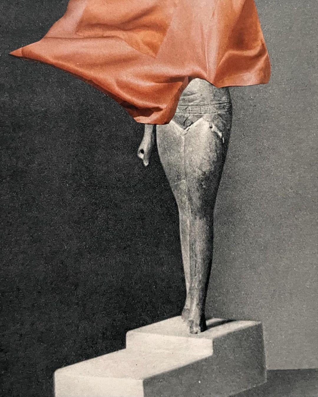 Monochrome image of a partial figure on steps, draped in red fabric, against a muted grey backdrop. Striking, artistic composition.