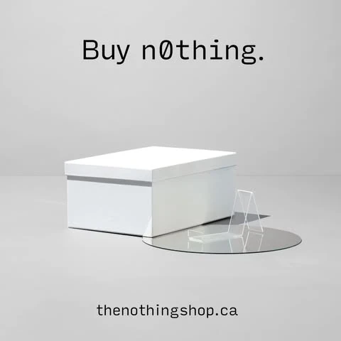 White box with lid displayed on a reflective disc, with the phrase 'Buy nothing' above and website address below, on a light background.