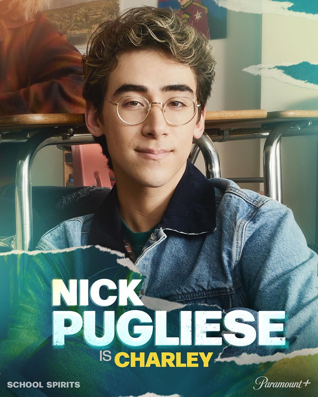 Close-up portrait of Nick Pugliese as Charley in 'School Spirits' with glasses, wearing a denim jacket in a school-like setting.