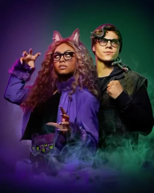 Two people pose in front of a purple and green background. One is wearing wolf ears and the other has a snake around his neck.