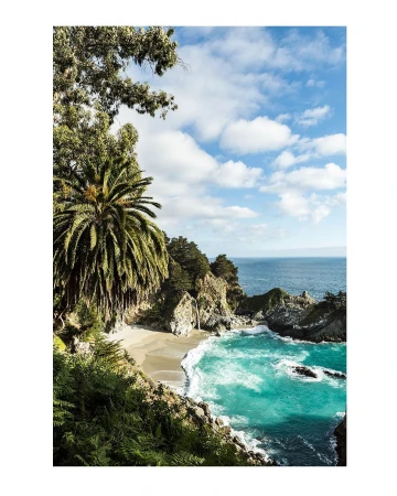 Scenic view of McWay Falls in Big Sur, California, with turquoise water, sandy beach, and lush greenery under a partly cloudy sky.