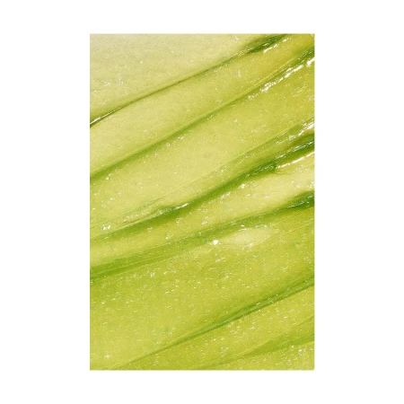 Macro shot of a light green cosmetic product with lines, showcasing its texture and color.