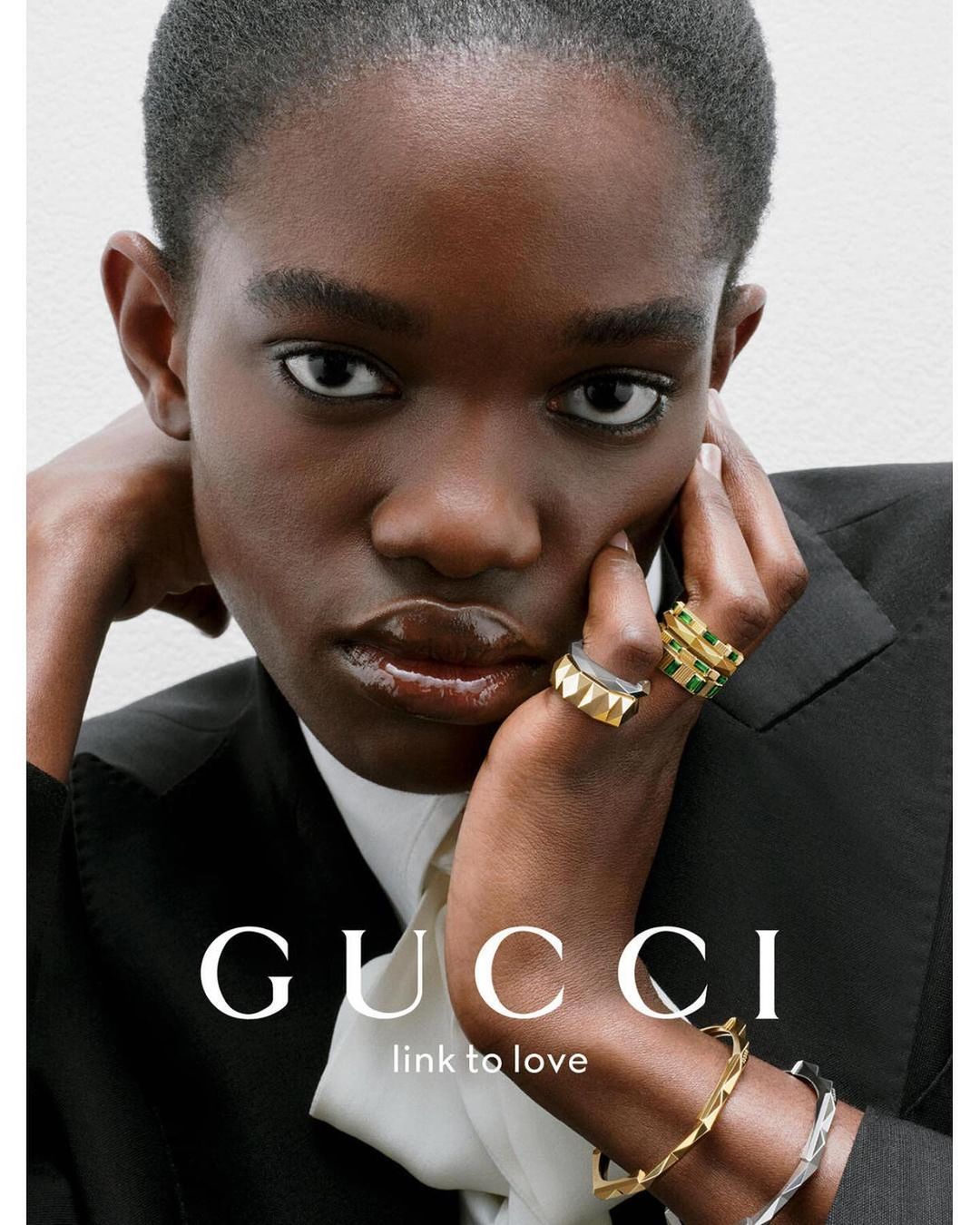 Close-up portrait of a Black woman wearing gold and silver geometric rings and bracelets by photographer Liv Liberg.