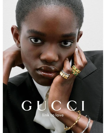 Close-up portrait of a Black woman wearing gold and silver geometric rings and bracelets by photographer Liv Liberg.