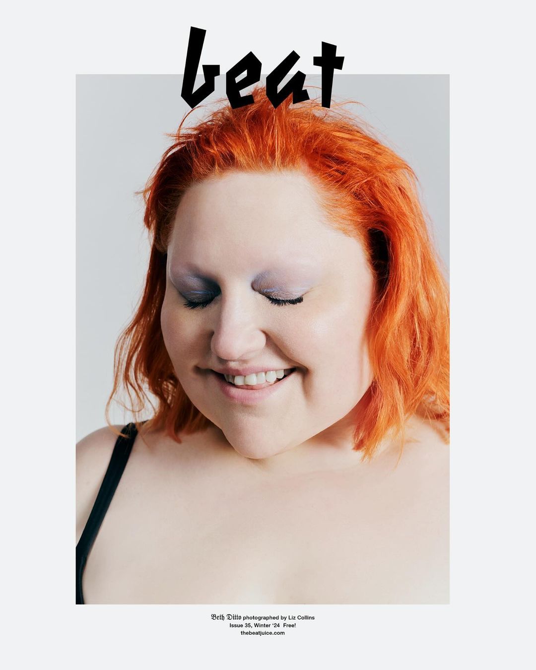Portrait of a smiling woman with bright orange hair and closed eyes against a plain white background with black text at top and bottom.
