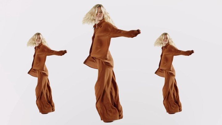 Three adult females with fair skin and blond hair pose in a brown satin two-piece outfit against a seamless white backdrop in a studio shot.