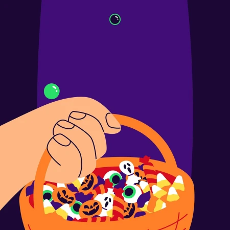 Illustration of a hand holding an orange basket filled with Halloween candies, including corn candy, pumpkins, and ghost shapes.