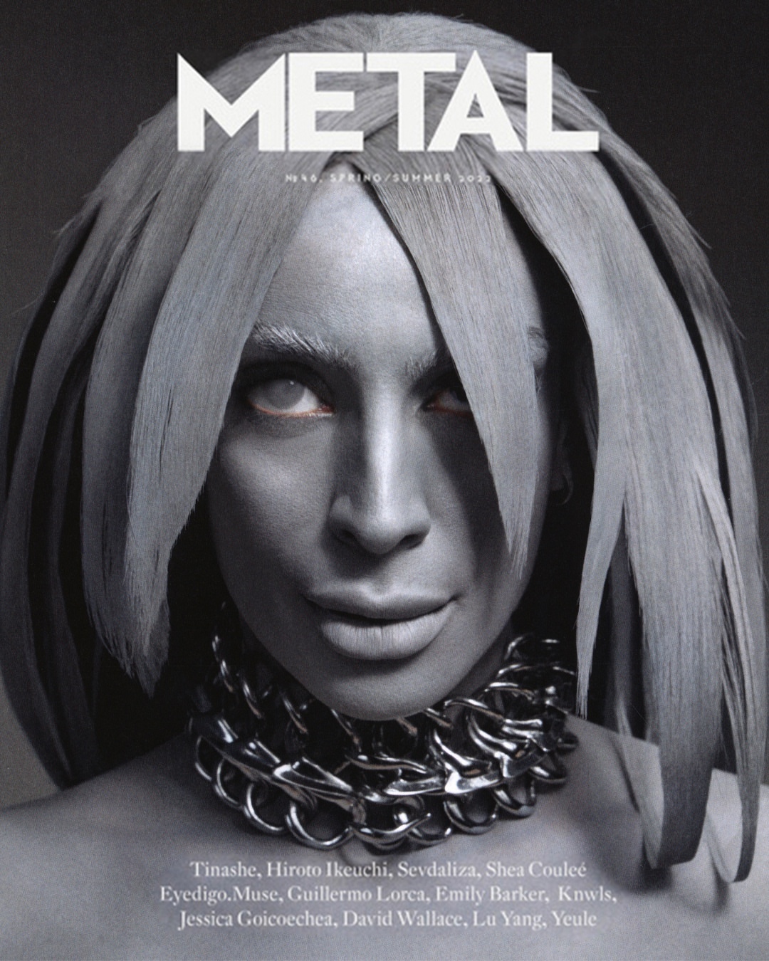 Metal Magazine cover featuring an adult female with silver body paint, chain necklace, and unique hairstyle against a dark gray background.