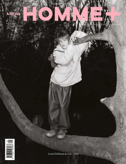 Magazine cover featuring a young man standing on a tree branch in a jacket and pants, with the magazine's title, Arena Homme+.
