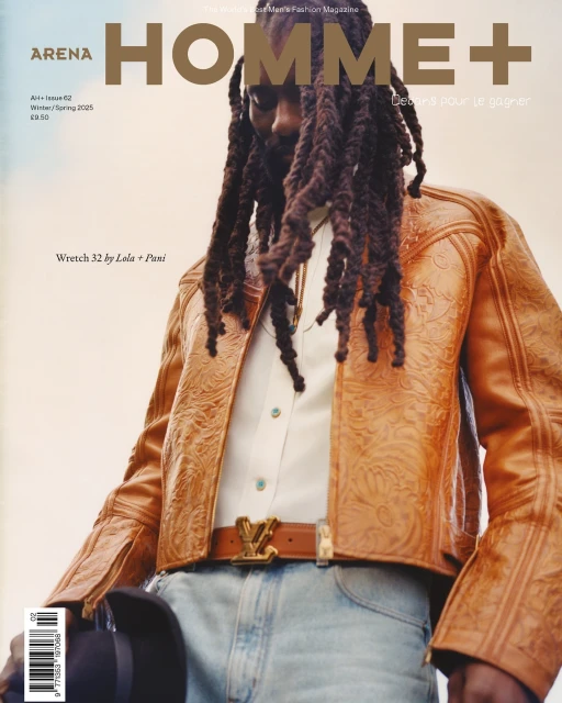 Magazine cover featuring a Black male model in an orange embossed leather jacket, jeans, and cowboy hat against a warm background.