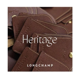 Close-up macro shot of textured brown leather tags and accessories with gold snap buttons and contrast stitching.