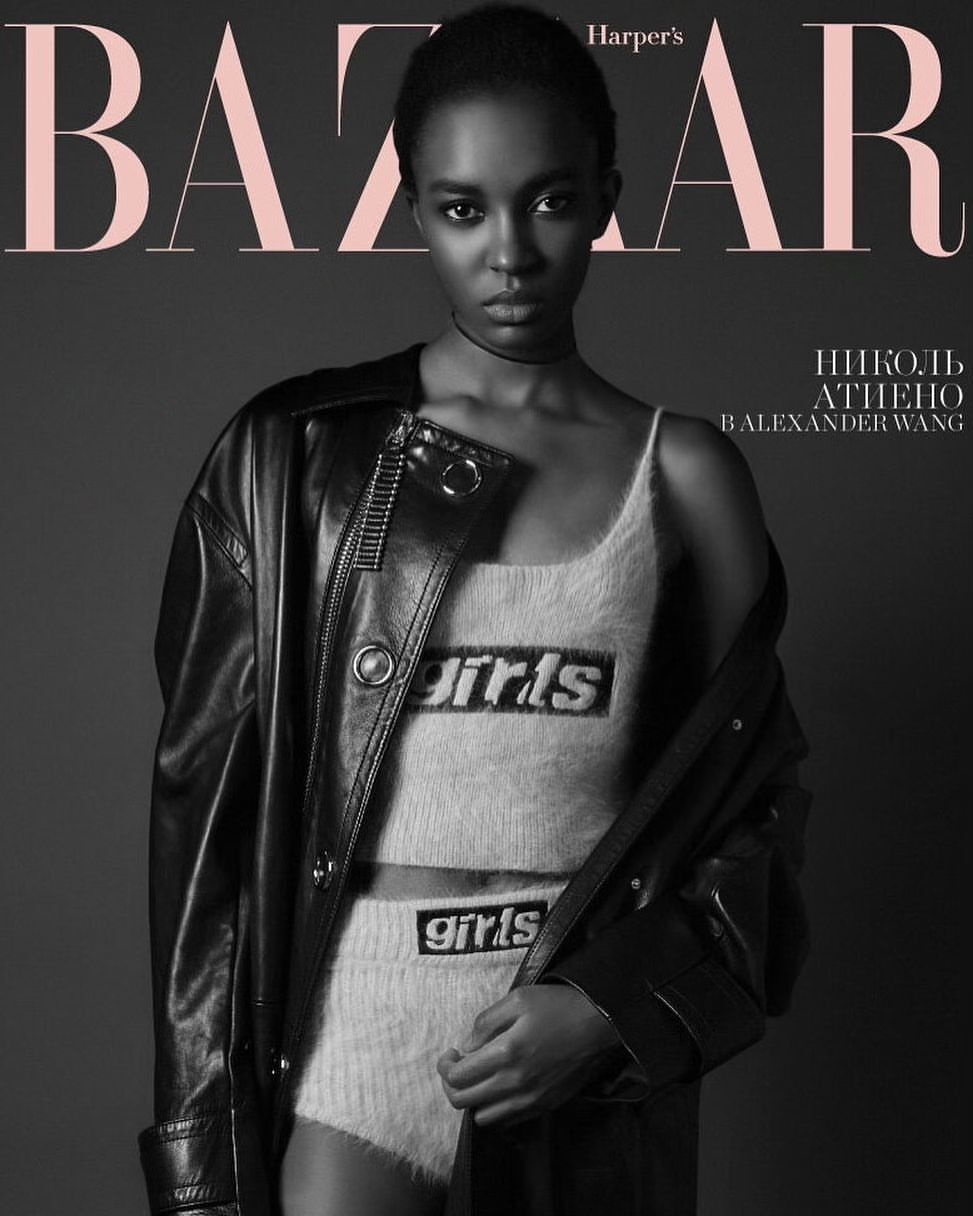 Black and white fashion cover featuring an African-American model wearing a top and shorts with the word 'girls' and a black jacket.