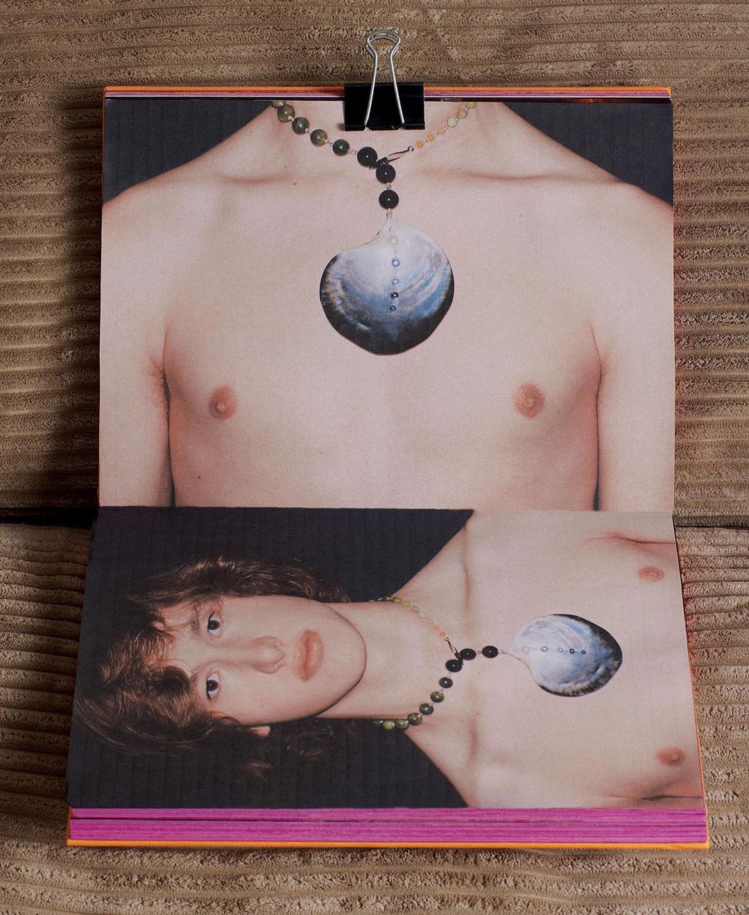 Art photograph features two open pages of a magazine held with a binder clip, showing two portrait photos of a shirtless human.