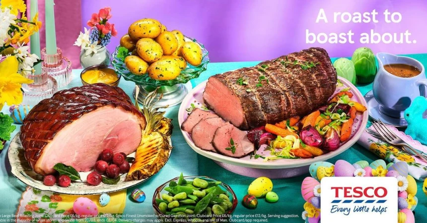 A colorful Easter-themed food still life with a ham, roast beef, potatoes, vegetables, and Easter decorations on a light blue tablecloth.