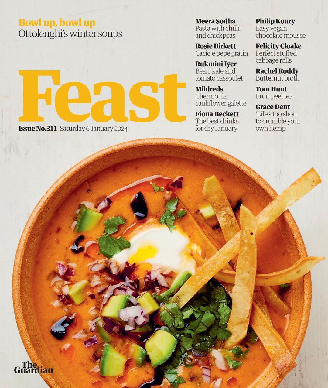 Food magazine cover featuring a bowl of winter soup garnished with avocado, tortilla strips, and herbs in a wooden bowl.