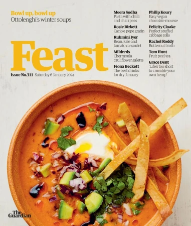 Food magazine cover featuring a bowl of winter soup garnished with avocado, tortilla strips, and herbs in a wooden bowl.