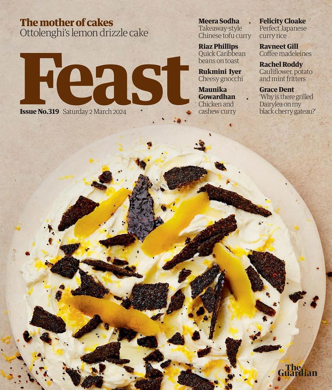 Overhead close-up of a 'Feast' magazine cover featuring a decorated lemon cake with icing, zest, and dark candied elements.
