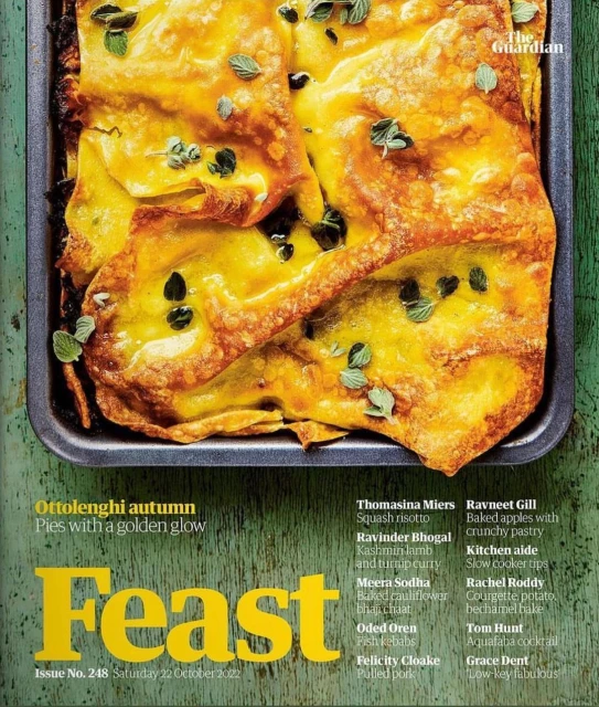 Overhead shot of golden crusted pies with herbs on a metal tray, magazine cover promoting Ottolenghi autumn pies.