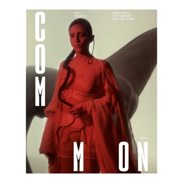 Magazine cover features a woman with braided hair wearing a sheer red garment alongside the faint silhouette of a horse in the background.